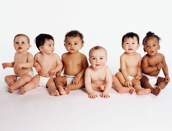 Six babies (18-21 months) sitting on the floor, portrait